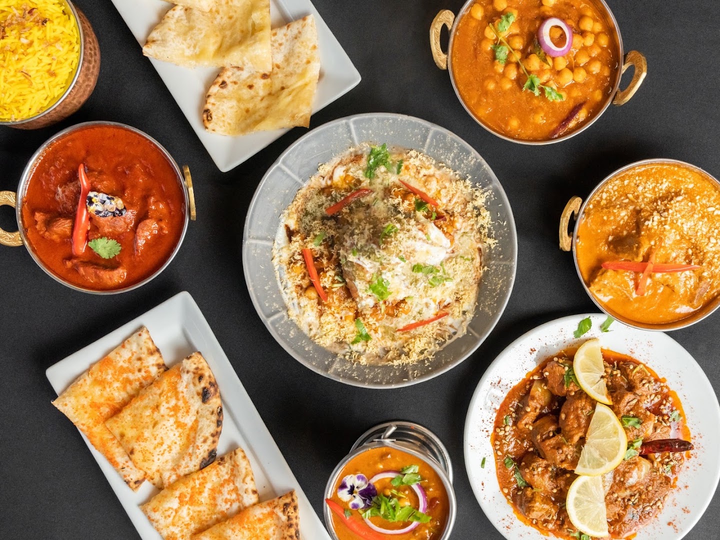 Raj on Taj's table: copper kadais of curry, saffron rice, naan and chaat on black slate